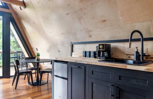 Johnson Cabin | Designer A-Frame Treehouse with hot tub on river