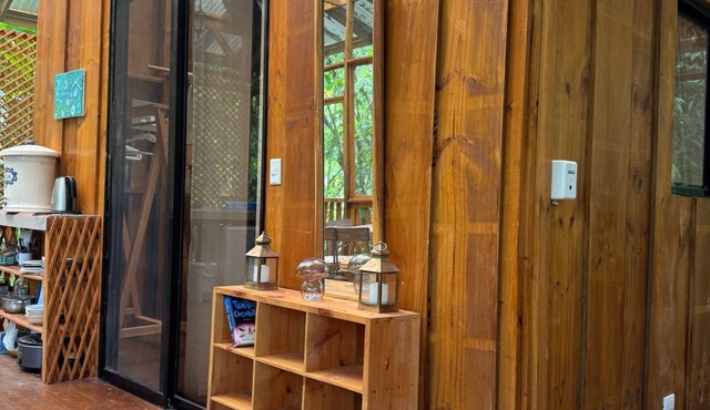 A wooden cabin immersed in nature, steps from the river.