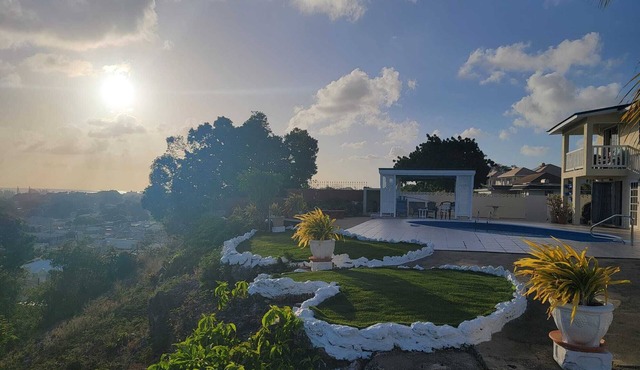 Hillside view and a pool